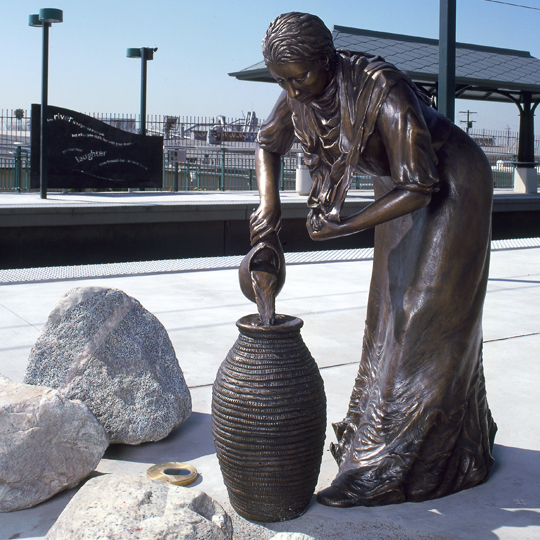 sculpture of Tongva woman pouring water